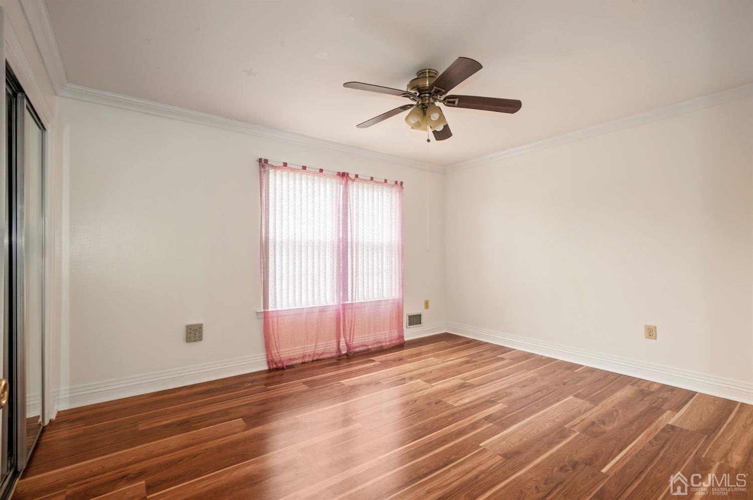 30 Brandywine Drive Old Bridge, NJ 07747 - Photo 18 of 39 a view of empty room with wooden floor and fan