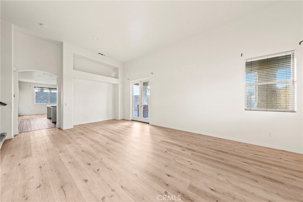 4660 Spice Street Lancaster, CA 93536 - Photo 11 of 42 a view of empty room with wooden floor and fan