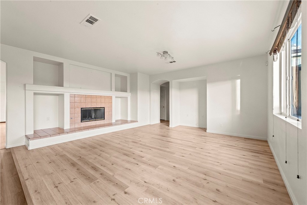 4660 Spice Street Lancaster, CA 93536 - Photo 15 of 42 a view of empty room with wooden floor and fireplace