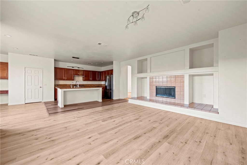 4660 Spice Street Lancaster, CA 93536 - Photo 17 of 42 a view of kitchen and empty room with wooden floor