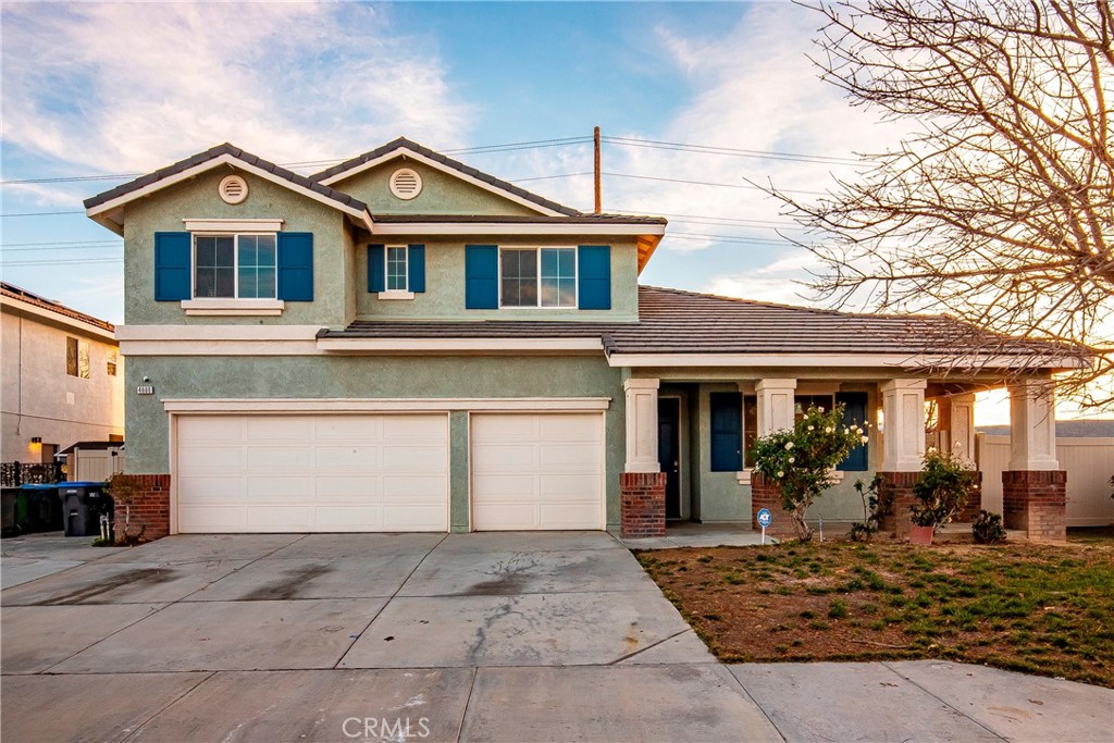 4660 Spice Street Lancaster, CA 93536 - Photo 2 of 42 a front view of a house with a yard and garage