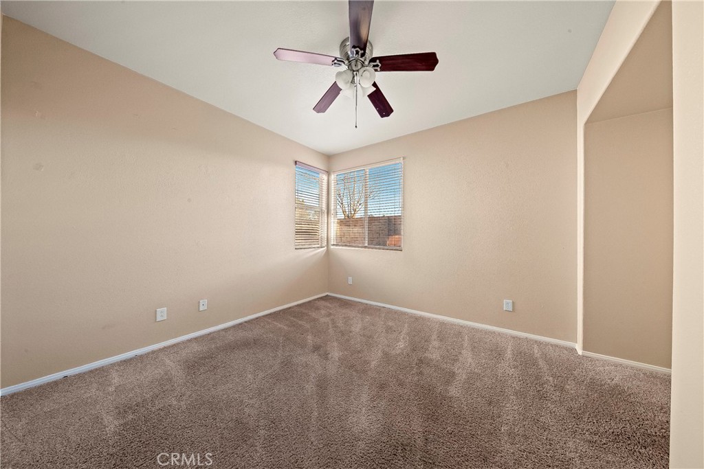 4660 Spice Street Lancaster, CA 93536 - Photo 23 of 42 an empty room with windows and fan