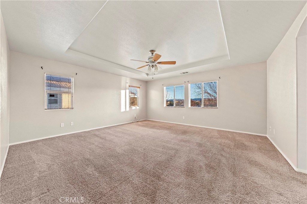 4660 Spice Street Lancaster, CA 93536 - Photo 26 of 42 an empty room with windows and ceiling fan