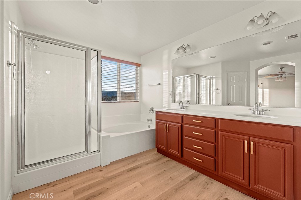 4660 Spice Street Lancaster, CA 93536 - Photo 27 of 42 a spacious bathroom with a tub sink and mirror