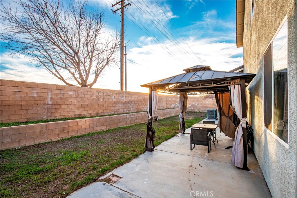 4660 Spice Street Lancaster, CA 93536 - Photo 36 of 42 a view of backyard with seating area and roof