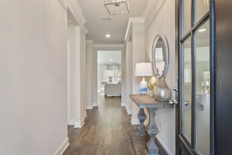 a view of a hallway with wooden floor fireplace and living room