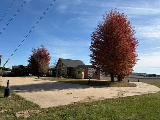 a view of a house with yard and lake view