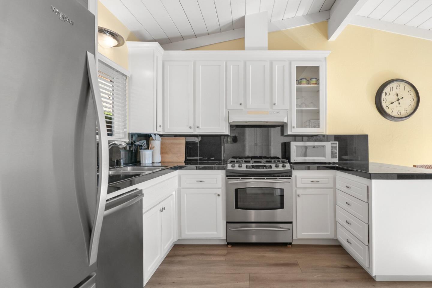 522 Spruce Street Aptos, CA 95003 - Photo 12 of 47 a kitchen with stainless steel appliances granite countertop a stove and white cabinets