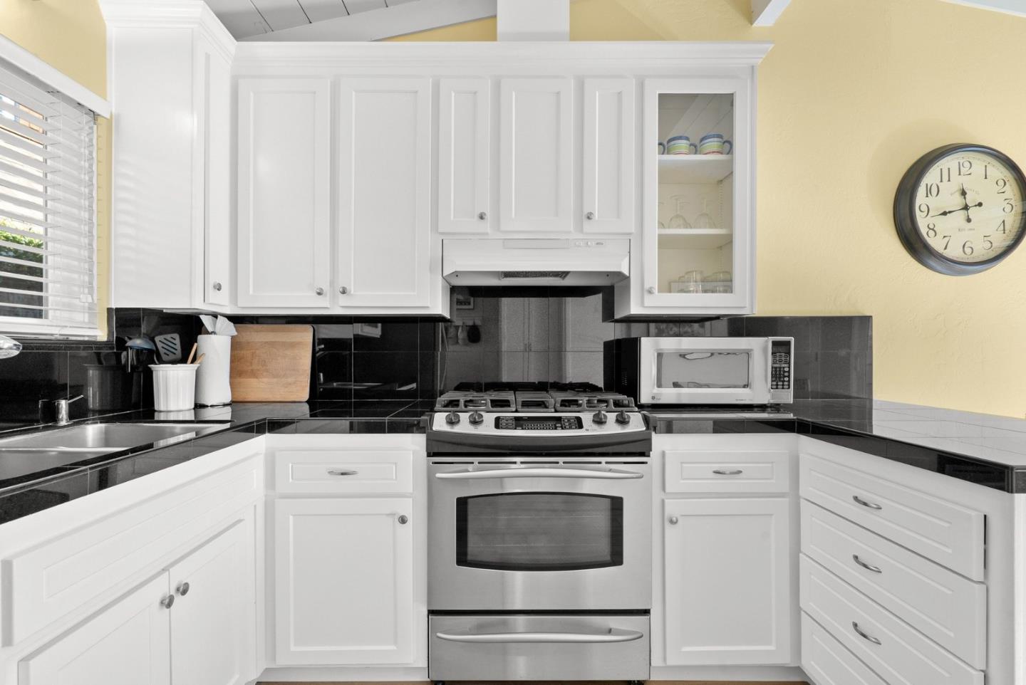 522 Spruce Street Aptos, CA 95003 - Photo 15 of 47 a kitchen with granite countertop white cabinets and stainless steel appliances