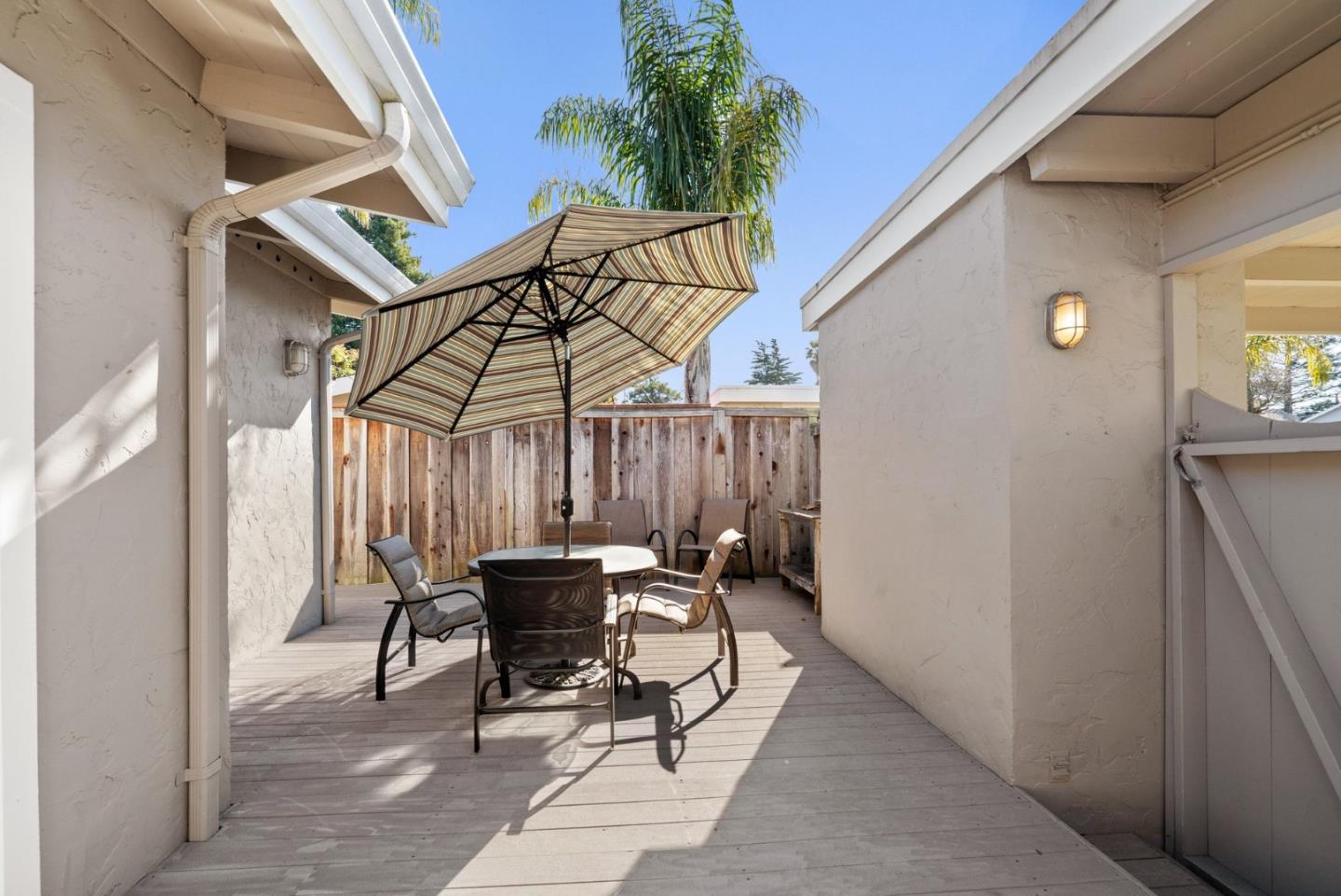 522 Spruce Street Aptos, CA 95003 - Photo 29 of 47 a patio with a table and chairs and potted plants