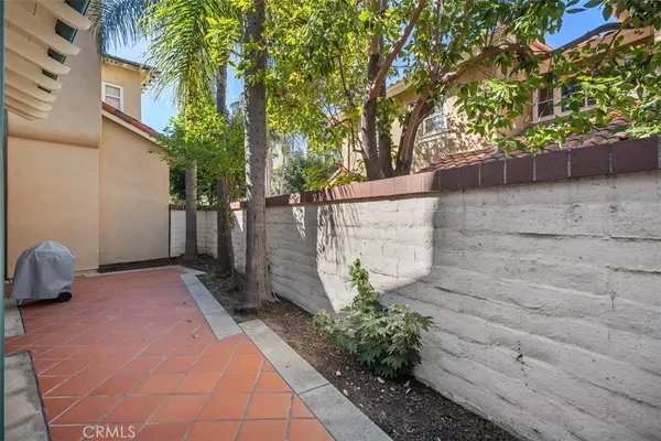 a pathway of a house with a yard