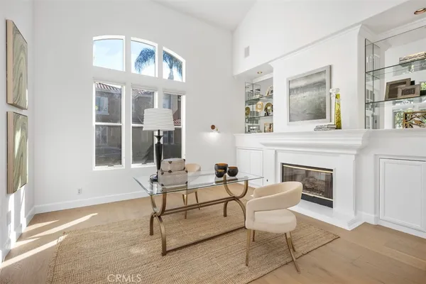 a living room with furniture a fireplace and large window