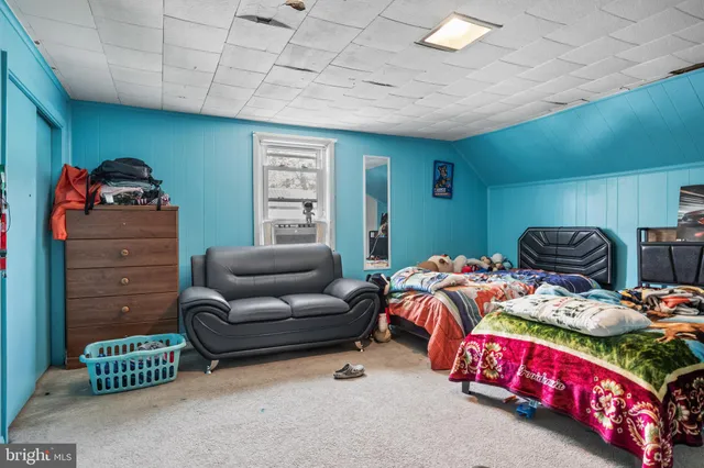 a bedroom with furniture and a window