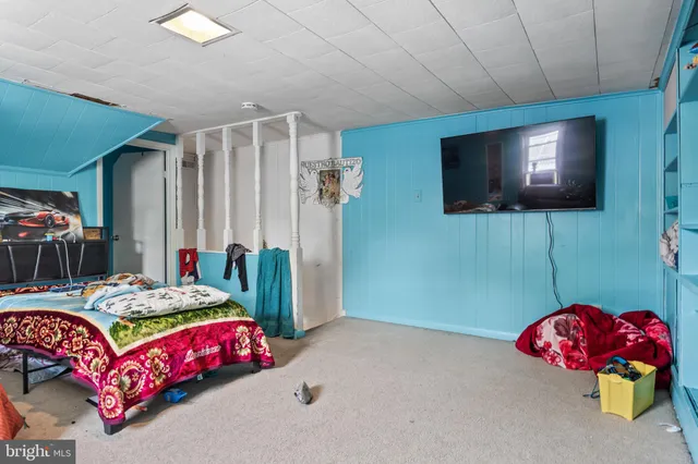 a bedroom with furniture and a flat screen tv