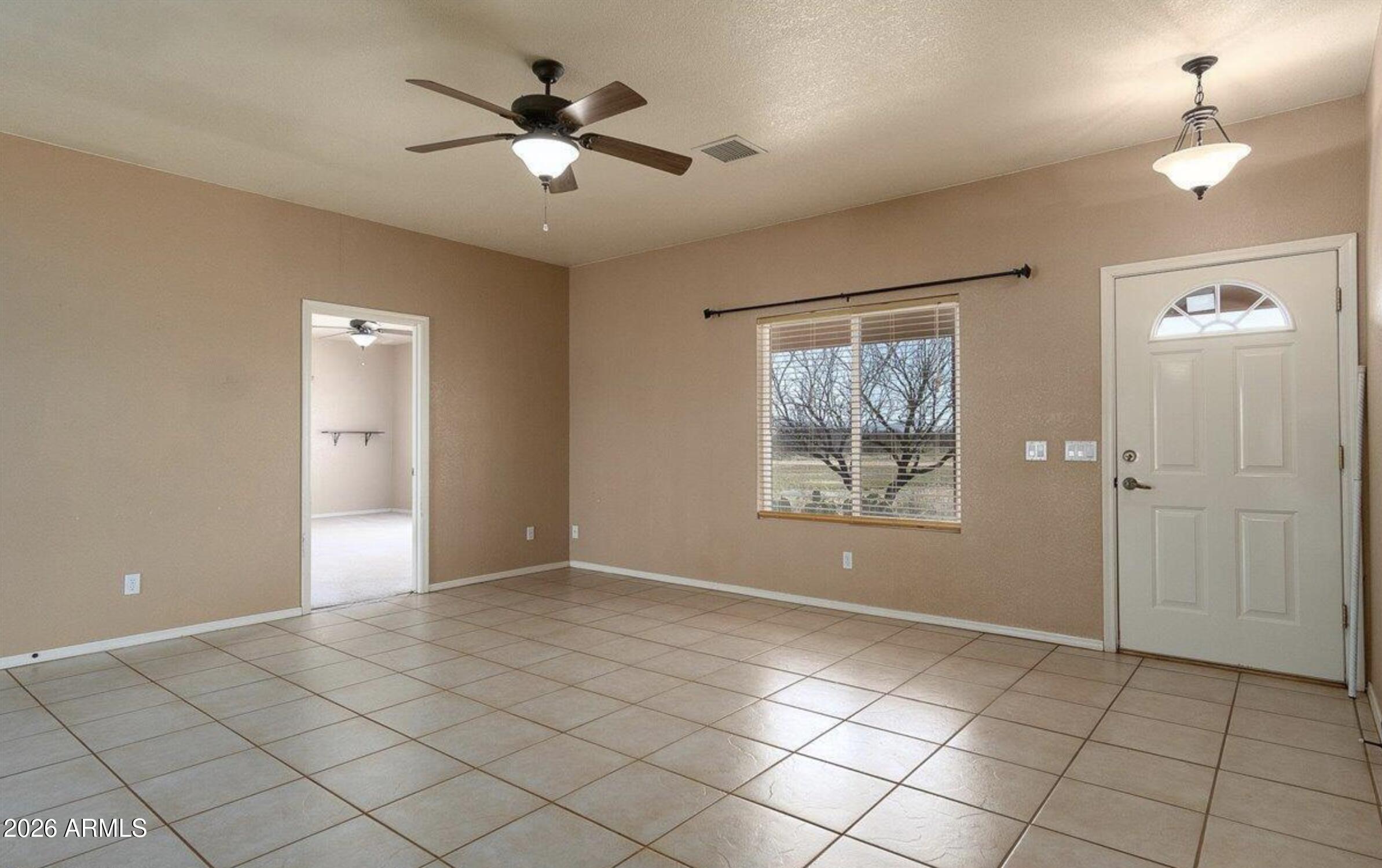 10193 East Windtalker Road Hereford, AZ 85615 - Photo 15 of 34 a view of an empty room with a window