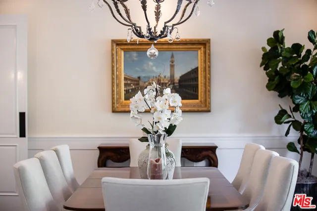 a living room with furniture a large window and wooden floor