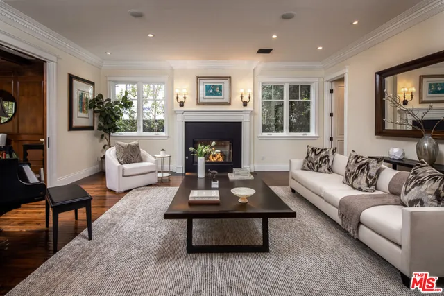 a living room with furniture fireplace and flat screen tv