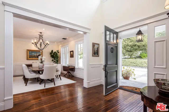 a kitchen with a sink a counter and chairs in it