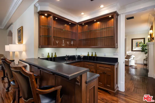 a dining room with furniture a chandelier and wooden floor