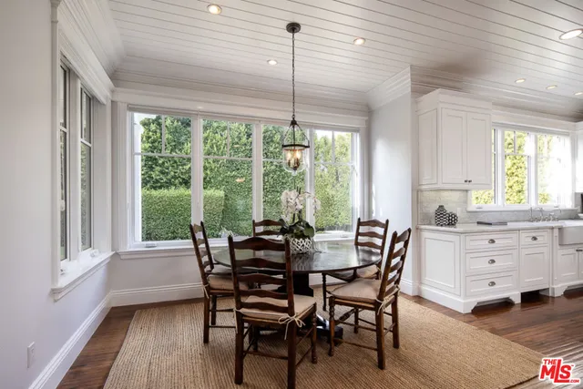 a kitchen with stainless steel appliances granite countertop a kitchen island hardwood floor and a sink
