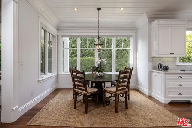 a kitchen with kitchen island a sink stove and wooden floor
