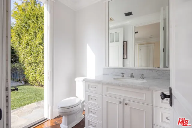 a view of hallway with a window and wooden floor