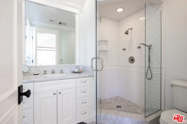 a spacious bedroom with a bed and a fireplace