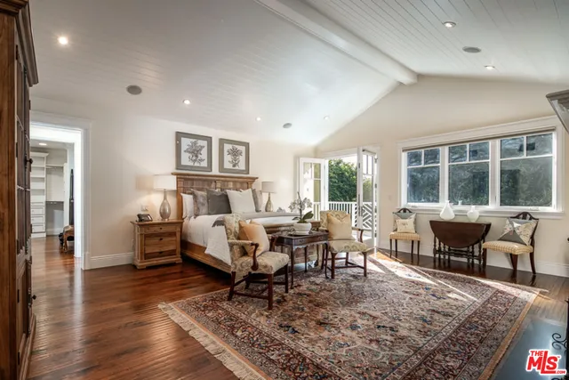 a living room with furniture a rug and a wooden floor