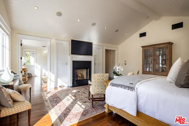 a spacious bathroom with a double vanity sink a large mirror and a bathtub