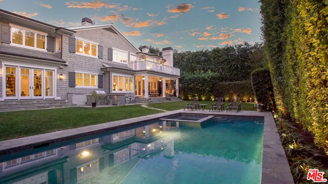 a front view of a house with a yard table and chairs
