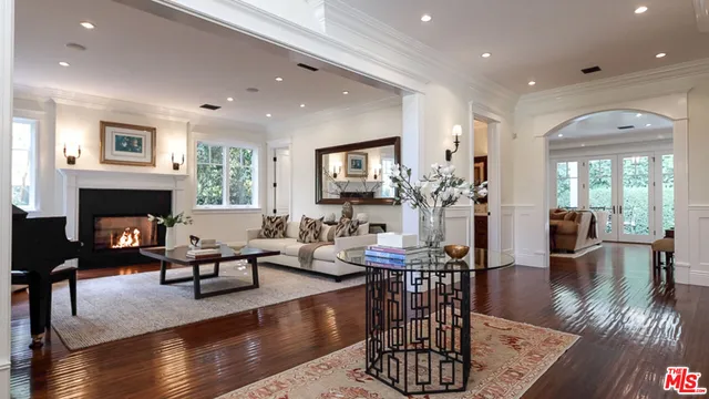 a living room with fireplace furniture and a wooden floor