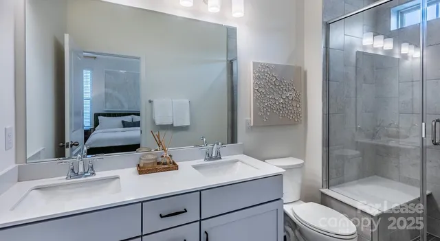 a spacious bedroom with a bed a mirror and a window