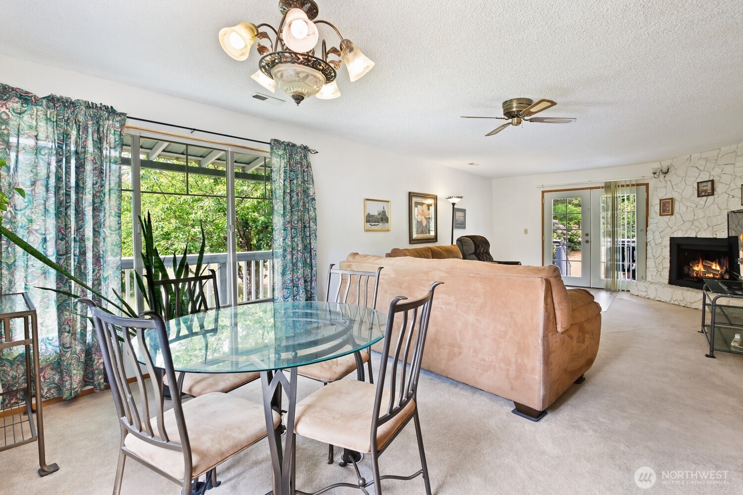 2670 Southeast Bielmeier Road Port Orchard, WA 98367 - Photo 7 of 39 a living room with a balcony a bed and a flat tv screen