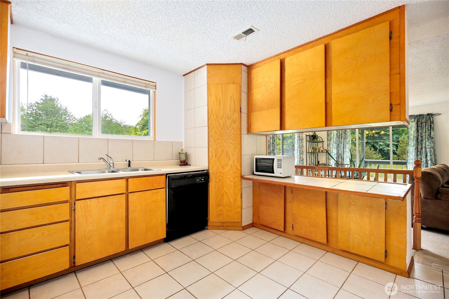 2670 Southeast Bielmeier Road Port Orchard, WA 98367 - Photo 10 of 39 a kitchen with stainless steel appliances a sink and a large window