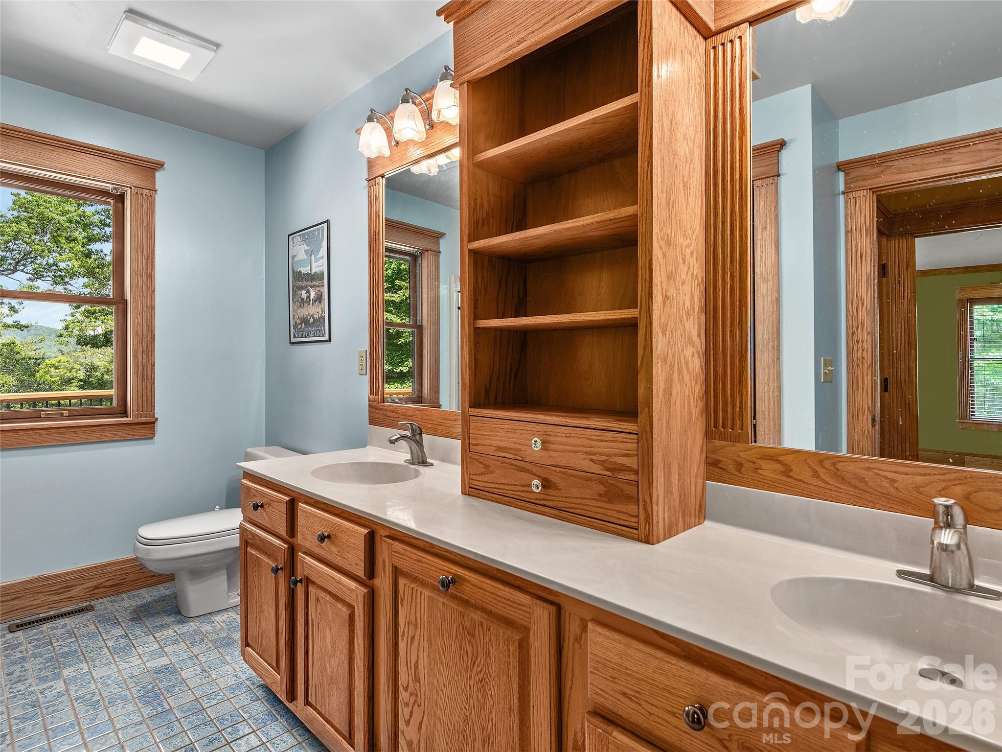 40 Deer Ridge Road Mills River, NC 28759 - Photo 27 of 35 a bathroom with a granite countertop sink and a mirror