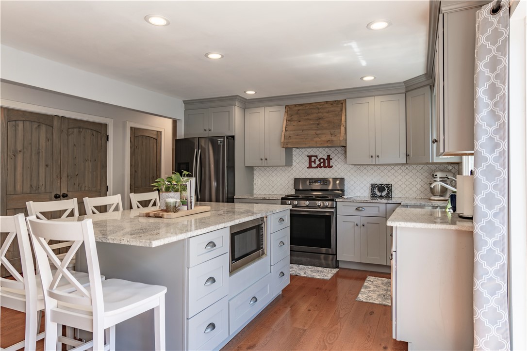 620 Seminole Point Road Fair Play, SC 29643 - Photo 19 of 50 Warm wood flooring pairs beautifully with classic shaker cabinetry and a central prep island.