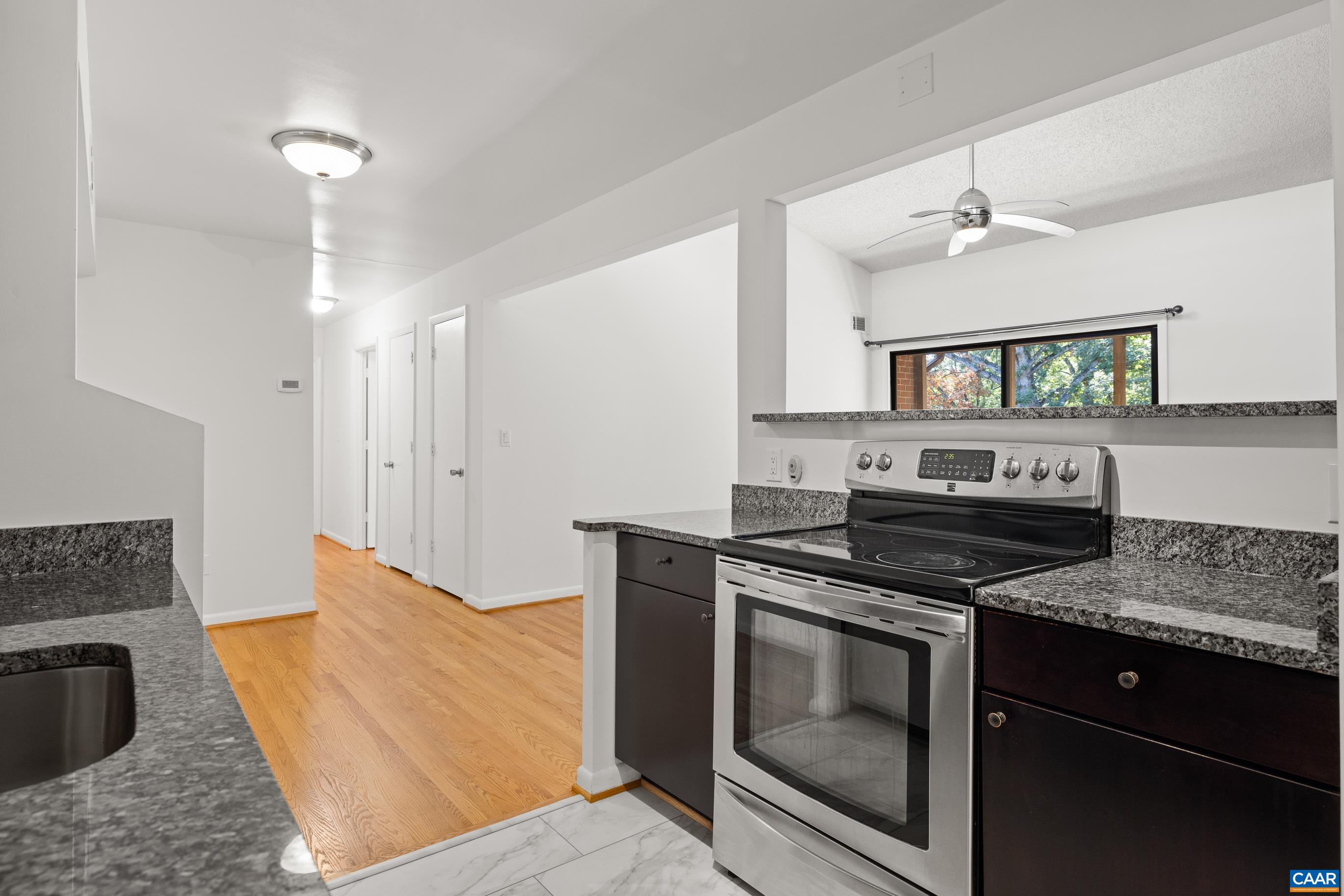 127 Turtle Creek Road, Unit 12 Charlottesville, VA 22901 - Photo 12 of 33 a kitchen with stainless steel appliances granite countertop a stove a sink and a refrigerator