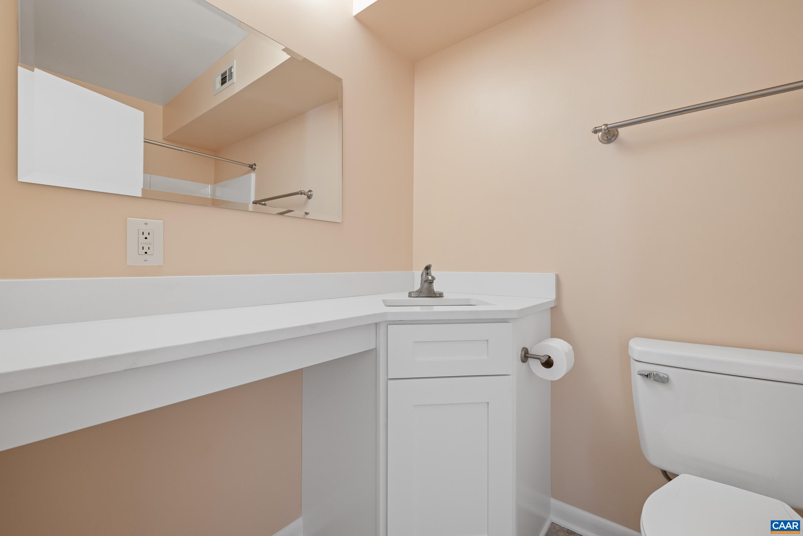 127 Turtle Creek Road, Unit 12 Charlottesville, VA 22901 - Photo 20 of 33 a bathroom with a sink mirror vanity and toilet