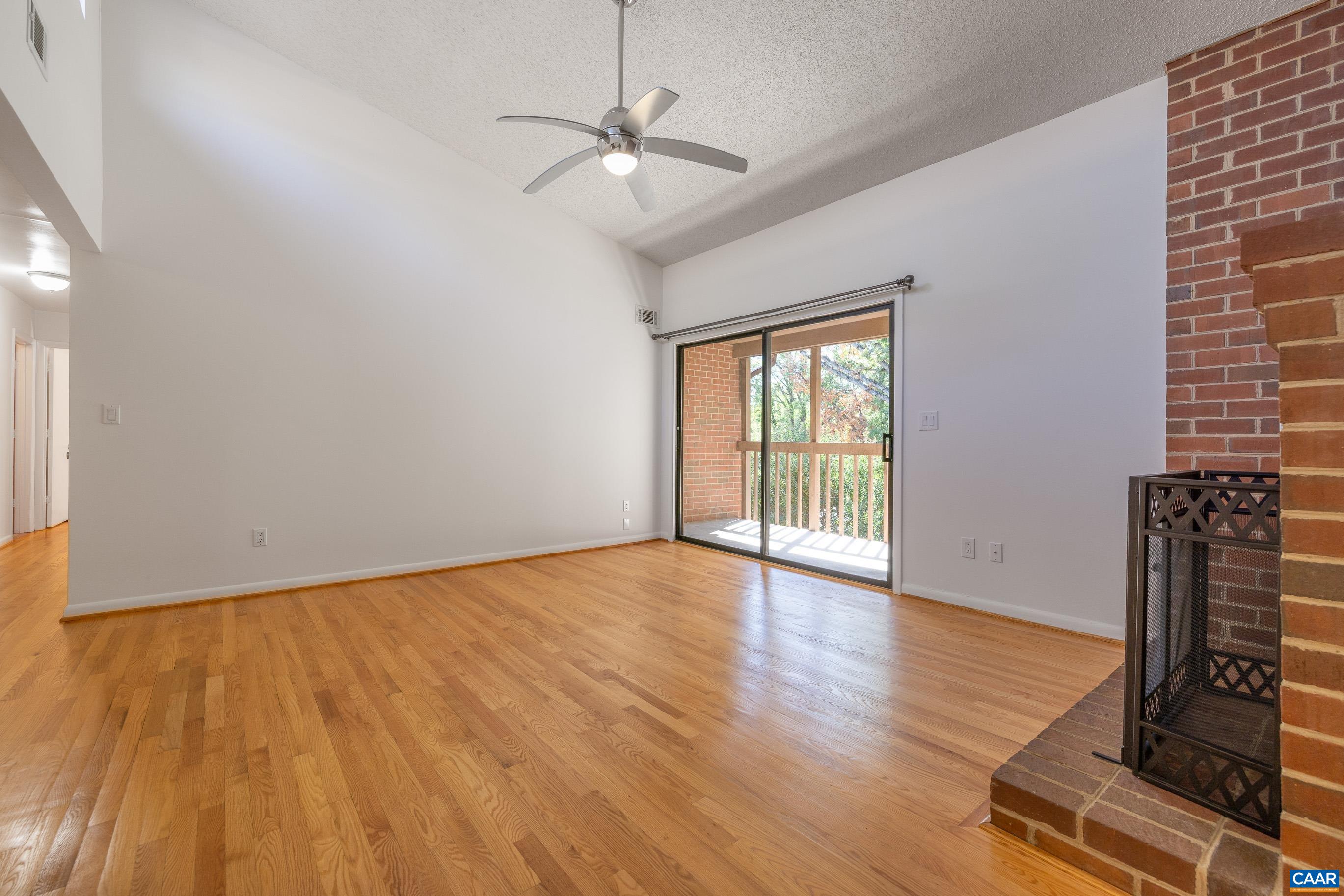 127 Turtle Creek Road, Unit 12 Charlottesville, VA 22901 - Photo 3 of 33 a view of an empty room with wooden floor and a window
