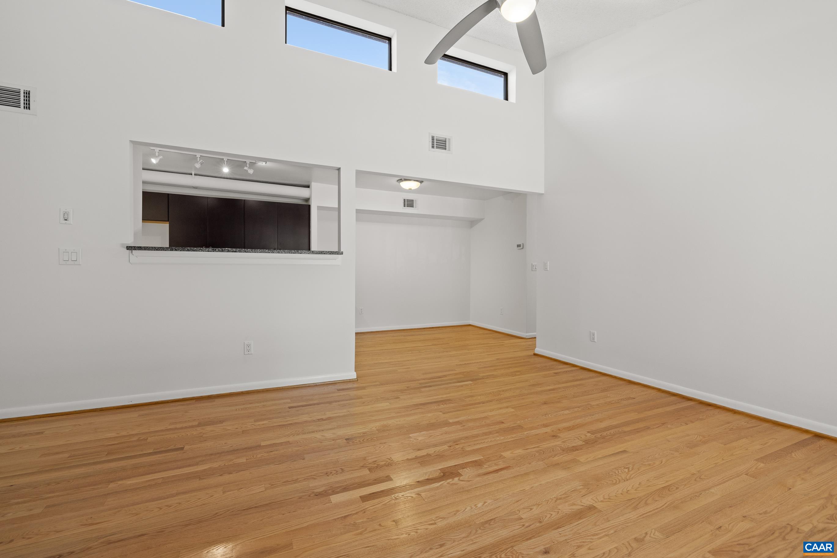 127 Turtle Creek Road, Unit 12 Charlottesville, VA 22901 - Photo 5 of 33 a view of empty room with wooden floor and fan