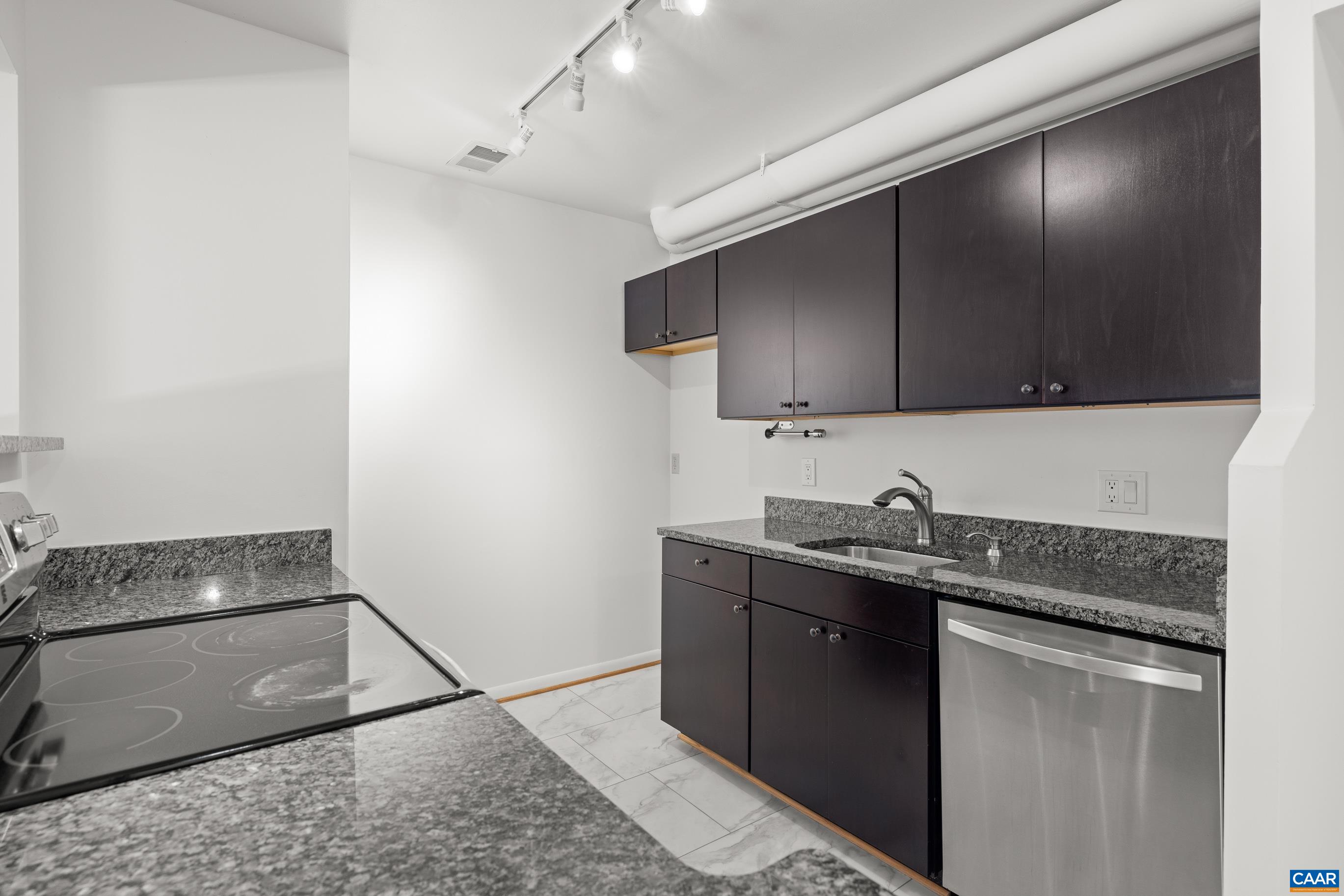127 Turtle Creek Road, Unit 12 Charlottesville, VA 22901 - Photo 10 of 33 a kitchen with stainless steel appliances granite countertop a sink stove and cabinets
