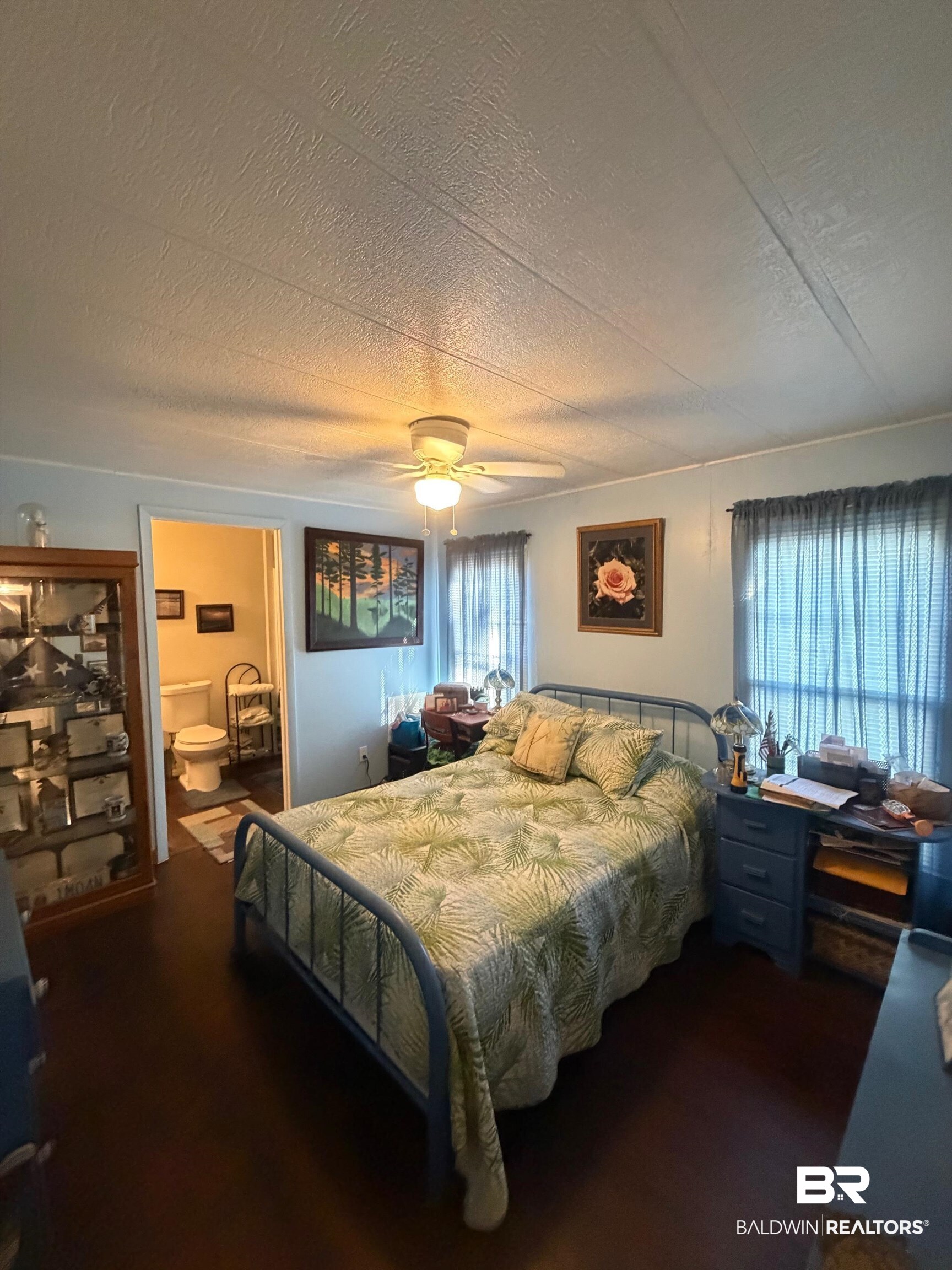 1430 Ridgewood Drive Lillian, AL 36549 - Photo 9 of 34 Bedroom with ceiling fan and a textured ceiling