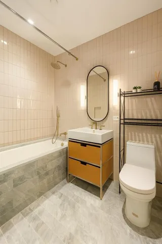 a bathroom with a toilet a sink and a mirror