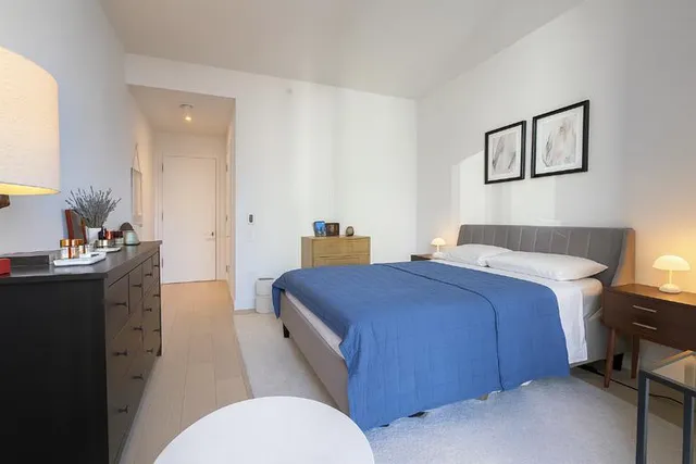 a bedroom with a bed and a dresser