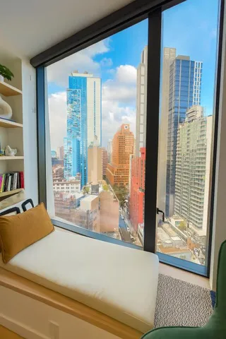 a room with a large window and a couch