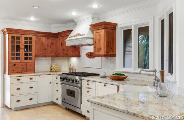 a kitchen with stainless steel appliances granite countertop a stove and a sink