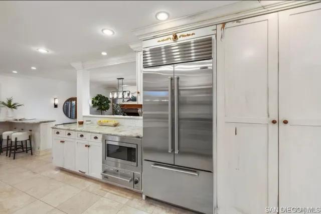 a kitchen with a refrigerator and cabinets