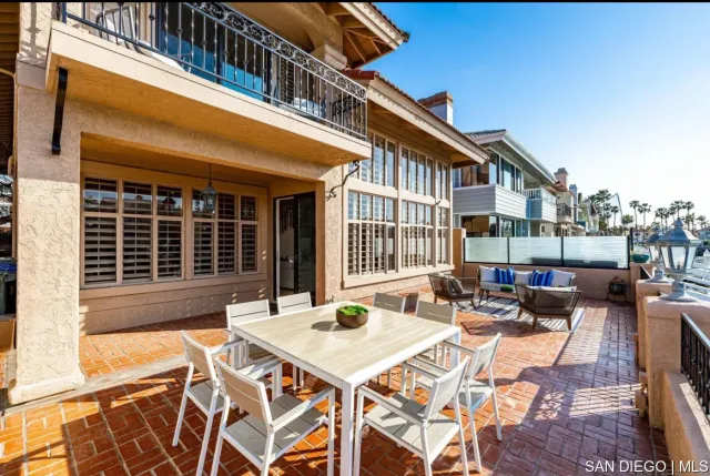 a view of a patio with table and chairs and potted plants