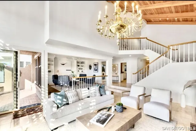 a living room with furniture chandelier and a chandelier