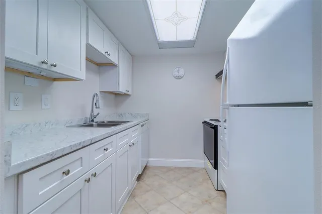a kitchen with a sink and refrigerator